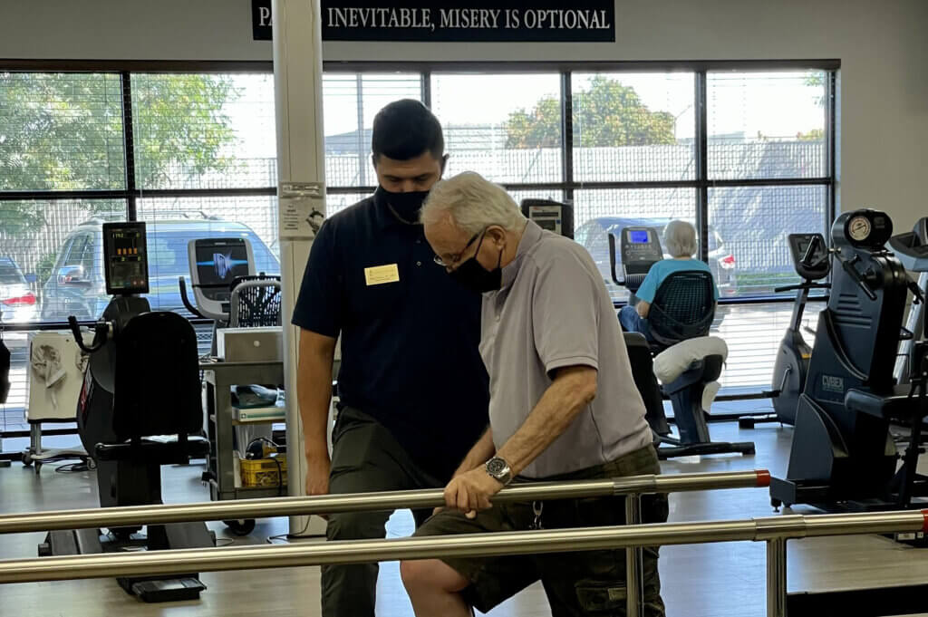 physical therapist works with patient