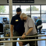 physical therapist works with patient
